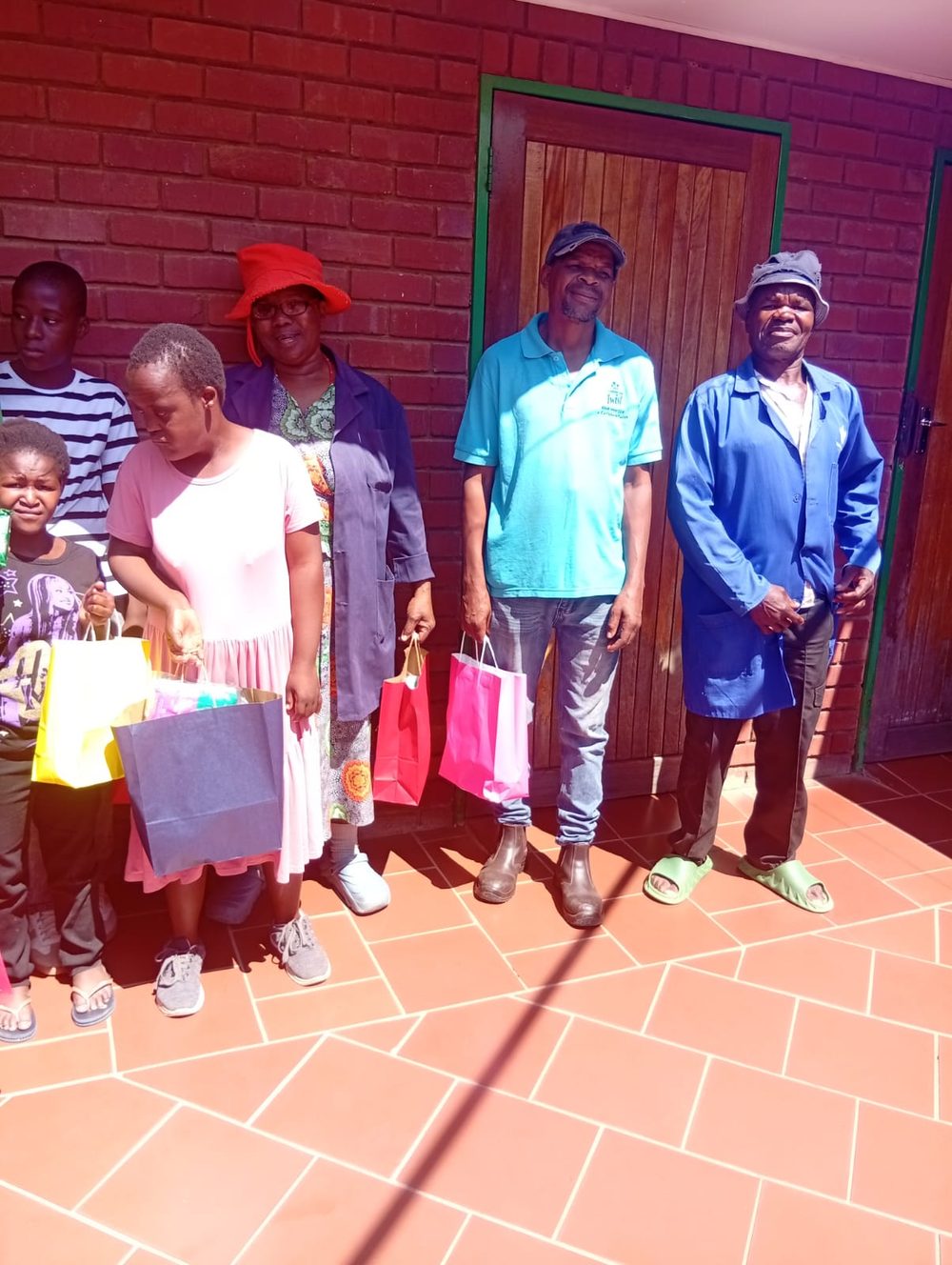 A family receiving gift bags at the centre
